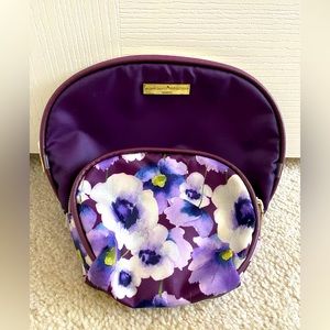 Two Adrienne Vittadini makeup or travel pouches; one purple, one flowered.